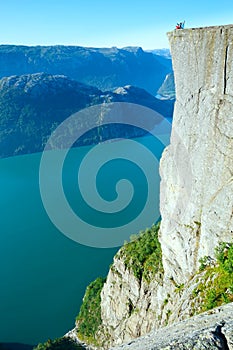 Happy family on Preikestolen massive cliff top (Norway)