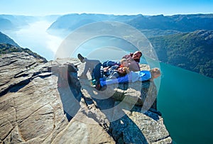 Happy family on Preikestolen massive cliff top (Norway)