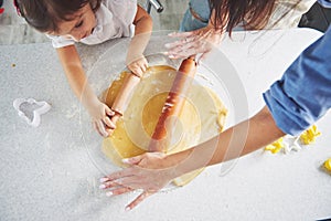 Happy family preparation holiday food concept. Family cooking Christmas cookies. Hands of mother and daughter preparing