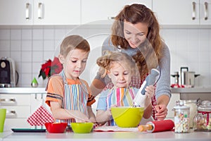 Happy family preparing cookies for Christmas eve