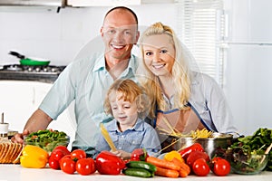 Happy family preparing a healthy dinner at home.