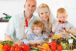 Happy family preparing a healthy dinner at home.