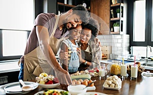 Happy family preparing healthy food in kitchen together