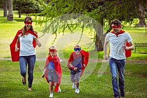 Happy family pretending to be superhero running