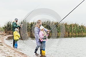 happy family in raincoats and boots