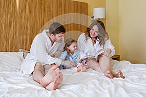 Happy family reading the book.