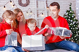 Happy family reading a book at home at christmas