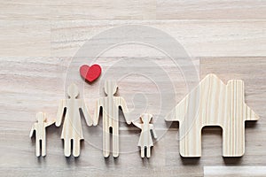 Happy family with Red heart and Model house on wooder background,Health care and insurance concept