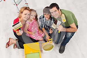 Happy family redecorating their home - painting