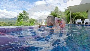 Happy family relax and looking natural view in the swimming pool. Family summer vacation.