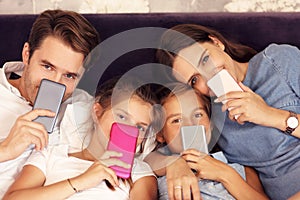 Happy family relaxing in hotel room