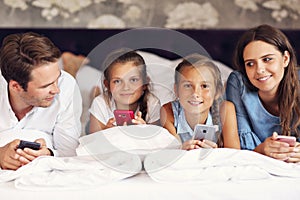 Happy family relaxing in hotel room