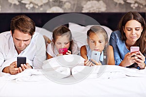 Happy family relaxing in hotel room