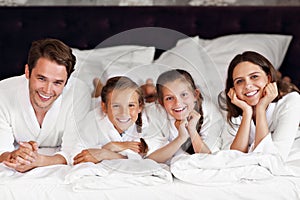 Happy family relaxing in hotel room