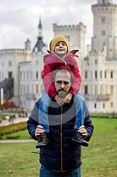 Happy family, relaxing in the park in front of beautiful renaissance castle Hluboka