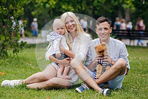 Happy family relaxing in the summer park