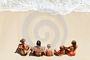 Happy family relaxing on white sand sea beach