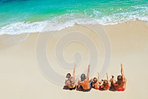 Happy family relaxing on white sand sea beach