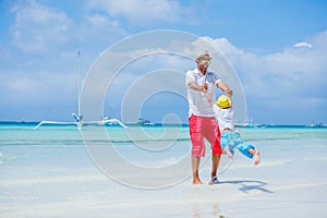 Happy family resting at beach in summer. Father with son resting on the beach. Father and his adorable little son on