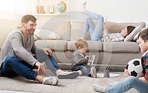 Happy family resting together on sofa at home