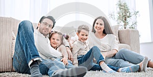 Happy family rests in the living room on a free evening