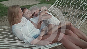 Happy family rides emotionally on hammock stock footage video