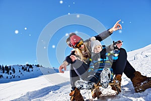 The happy family rides the sledge in the winter wood, cheerful winter entertainments