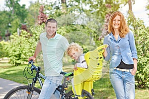 Happy family riding bike at the park