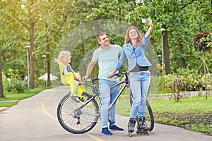 Happy family riding bike at the park