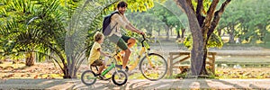 Happy family is riding bikes outdoors and smiling. Father on a bike and son on a balancebike BANNER, long format