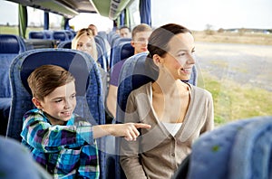 Happy family riding in travel bus