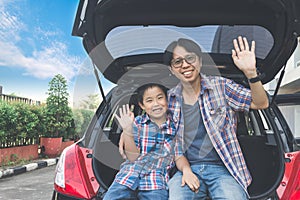 Happy family on a road trip, Sitting In Trunk Of Car