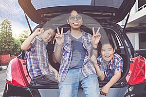 Happy family on a road trip, Sitting In Trunk Of Car