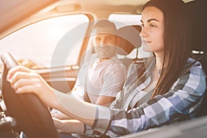 Happy family on a road trip in their car. Dad, mom and daughter are traveling by the sea or the ocean or the river