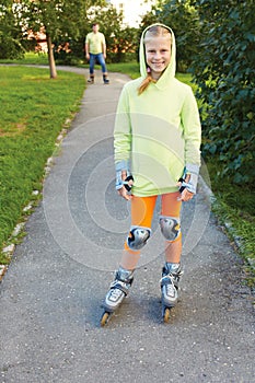 Happy family on roller skates in park.