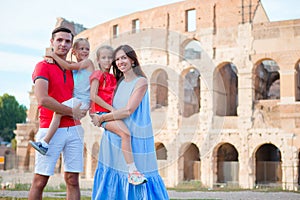 Happy family in Rome over Coliseum background. Italian european vacation together
