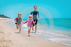 Happy family run and play on beach vacation, father and little daughter have fun