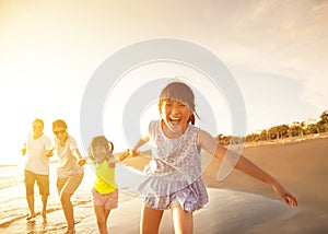 Happy family running on the beach