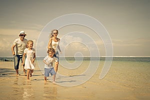 Happy family running at the beach
