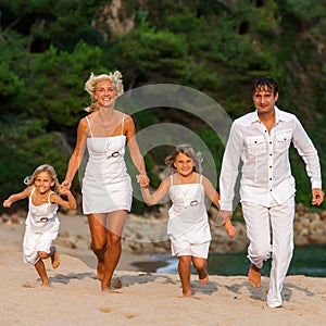 Happy family running together.
