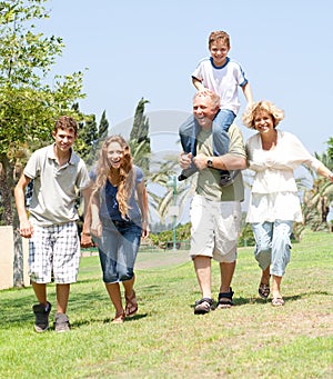 Happy family running towards camera