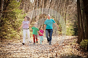 Happy Family Running in the Woods