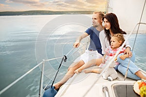Happy family sailing on boat