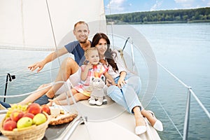 Happy family sailing on boat