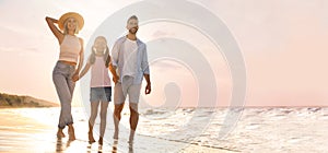 Happy family on sandy beach near sea, space for text. Banner design