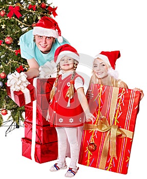Happy family in santa hat holding gift box.