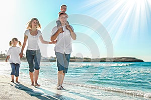 Happy family by the sea in the open air