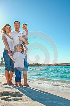 Happy family by the sea in the open air