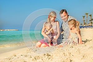 Happy family by the sea in the open air