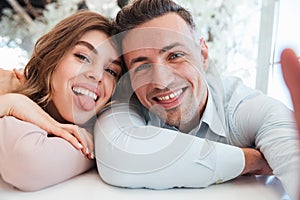 Happy family selfie of amusing man and woman having fun together